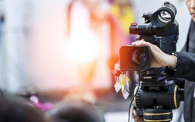 Video camera operator working with their equipment